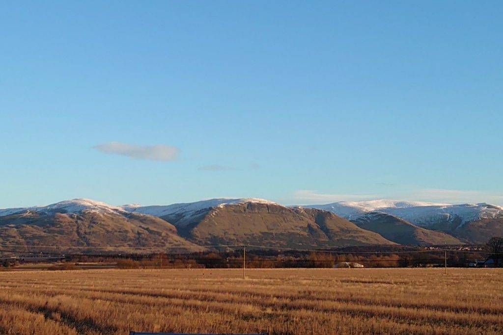Snow-capped Ochil Hills range near Stirling in Central Scotland - visible from Fallin - a nearby ex-miners community 